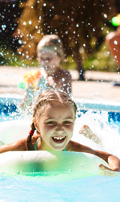 Children splashing happily in a clean, well-maintained pool in Winter Springs, FL