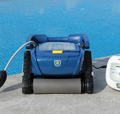 Robotic pool cleaner and control unit on the deck during weekly pool service in Paradise Heights, FL