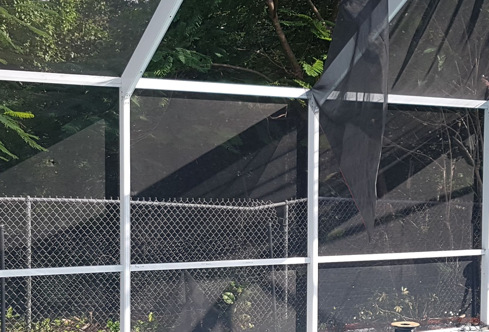 Close view of a white aluminum pool cage frame