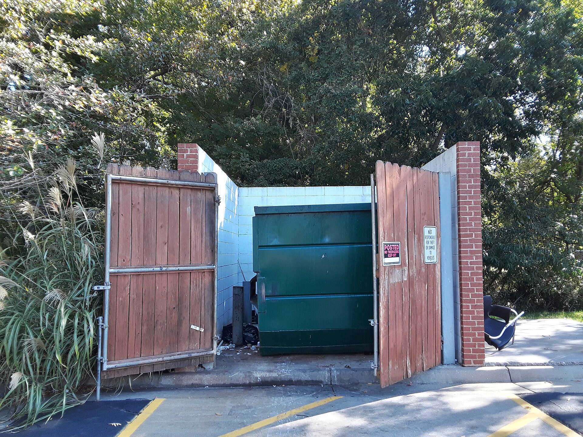 Commercial dumpster corral with block walls and gates