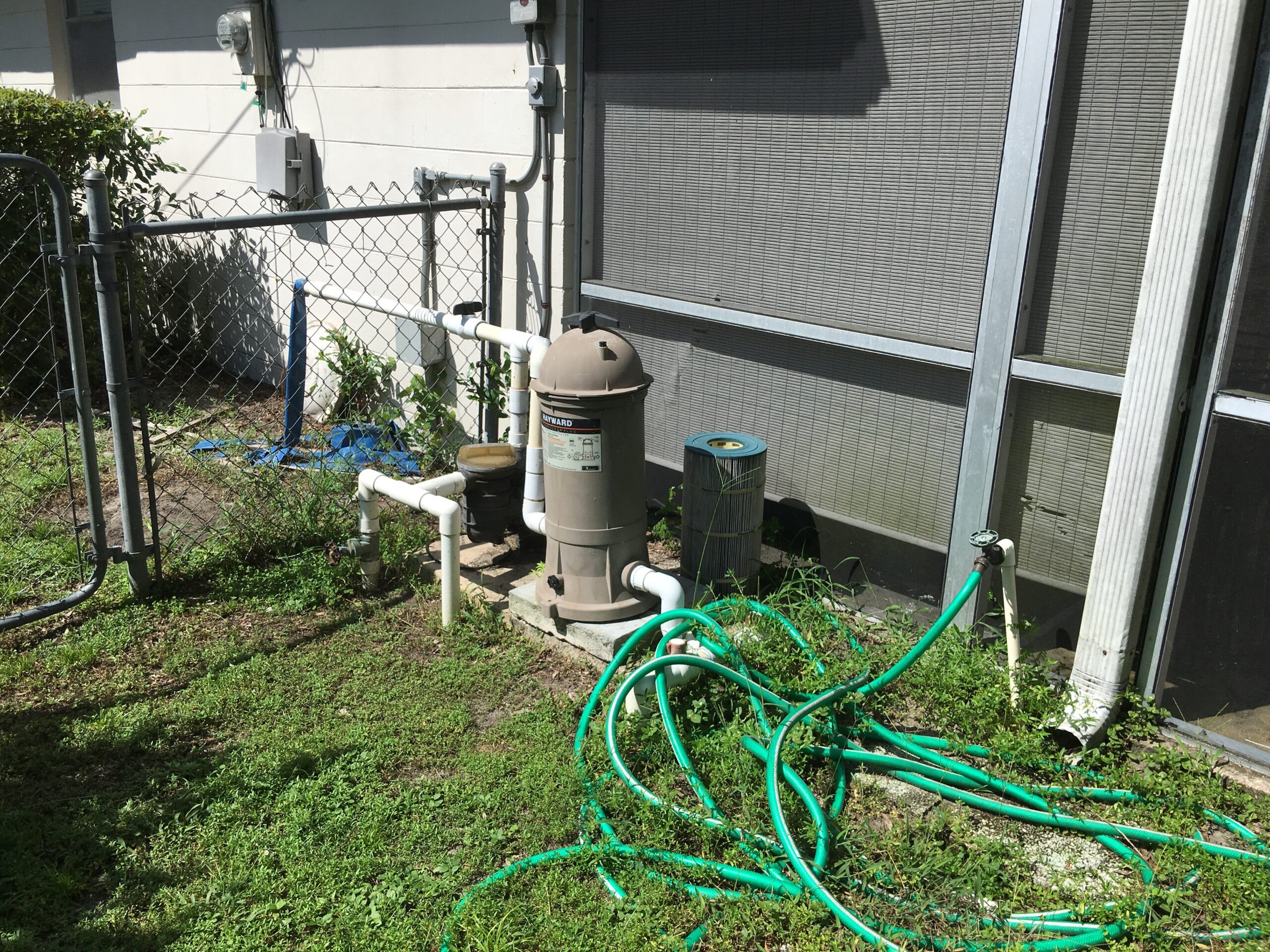 Pool equipment pad with filter canister and PVC plumbing