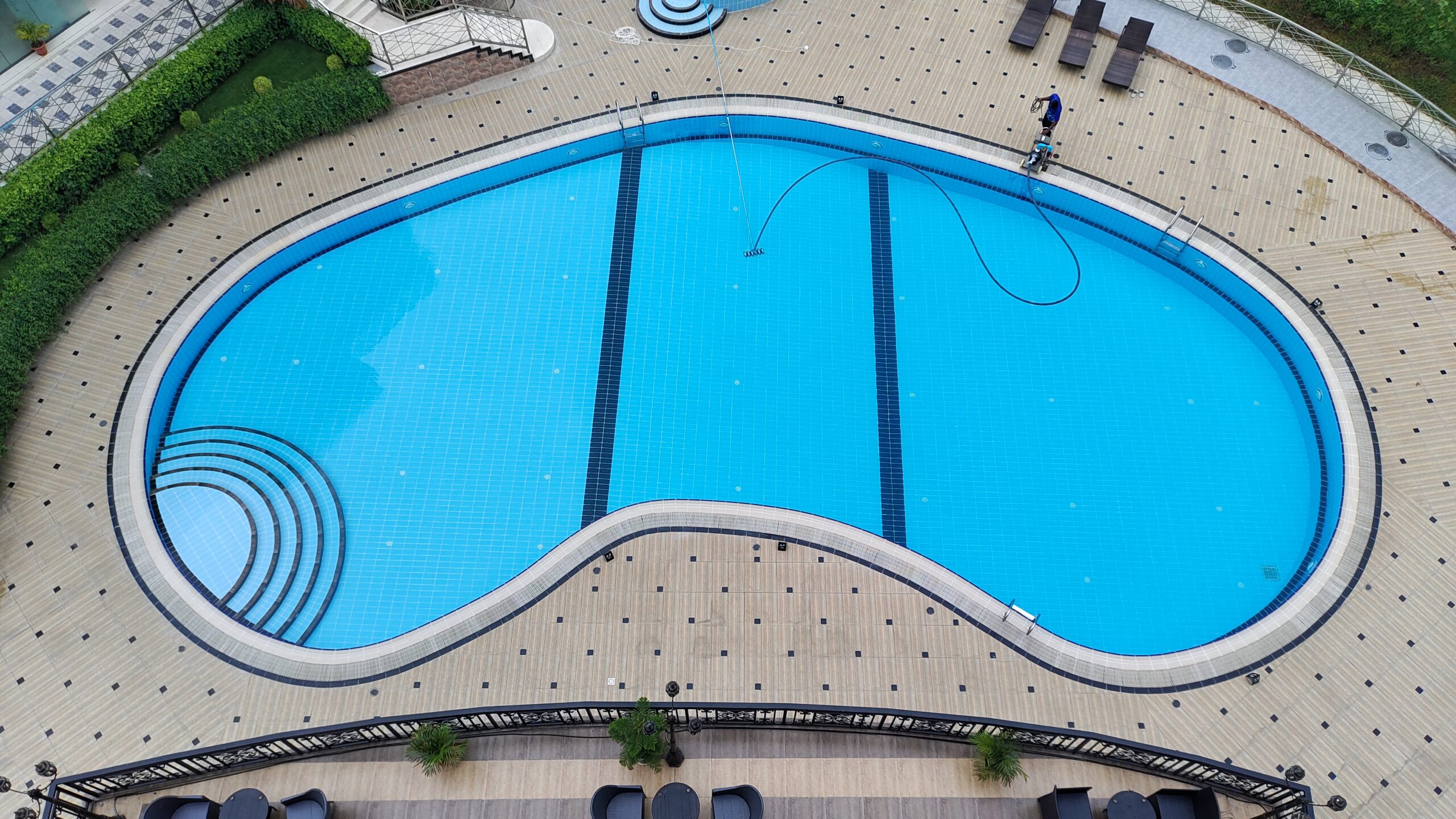 Aerial view of a clean kidney-shaped swimming pool